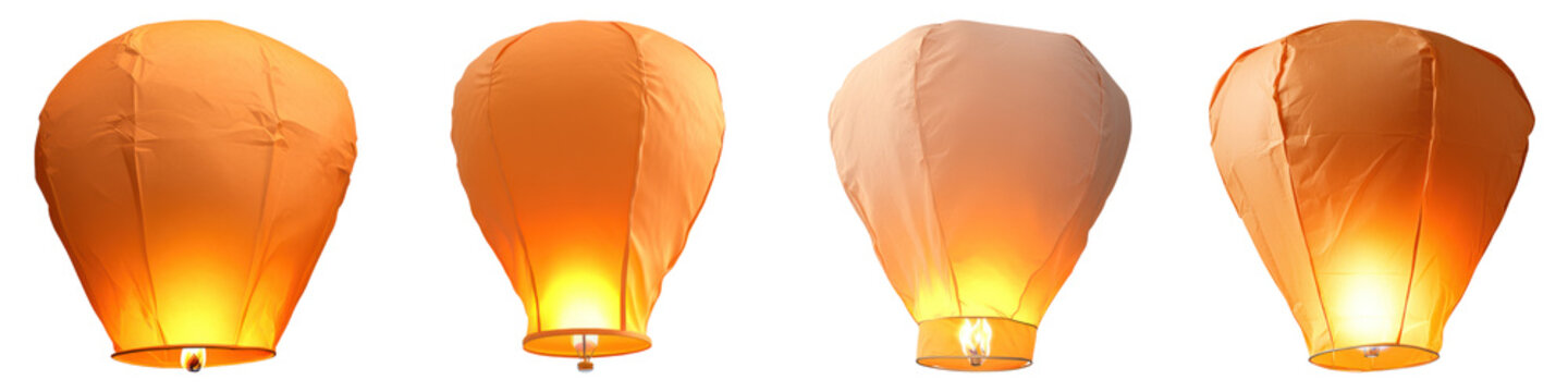 Floating sky lanterns glowing in night sky, symbolizing wishes and hope