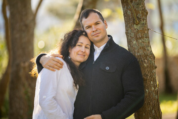 Happy couple embracing in nature, celebrating love and connection