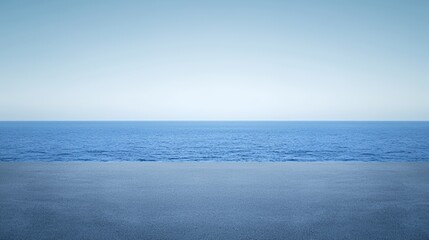 Obraz premium Serene Seascape: Blue Ocean and Sandy Beach Under a Clear Sky
