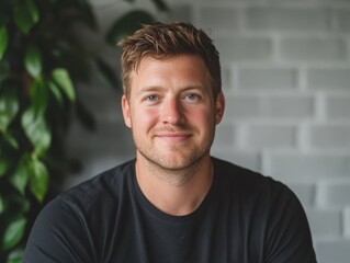 Fototapeta premium Casual, Friendly Headshot of a Young Caucasian Man Smiling in a Black Shirt