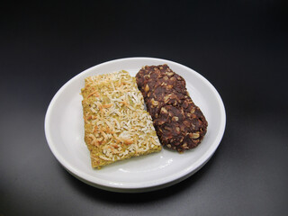 Delicious rice and chocolate snacks displayed on a white plate against a dark background