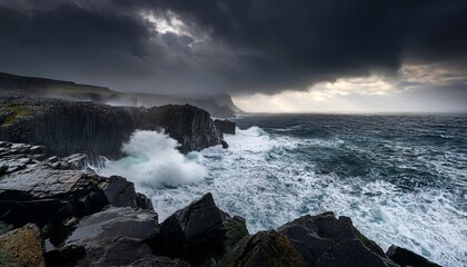 Obraz premium A dramatic stormy coastline with massive waves crashing against jagged black cliffs, creating a powerful, raw natural landscape.