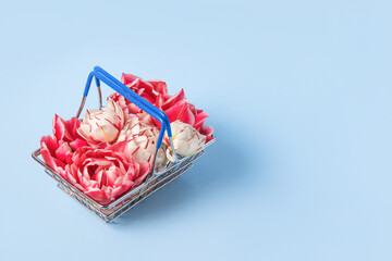 Shopping and gift basket with pink tulip flowers. Concept Valentine's day, gift package and delivery. Sale, shopping, promotion, pleasant surprises, black friday