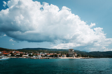 Scenic Coastal Town with Tower and Mountains