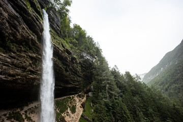 Pericnik waterfall is a beautiful drop from the mountain cliff, in Triglav National Park. Slovenian waterfall. Long for walking and trekking, enter inside the cave to admire it. Powerful and majesty.