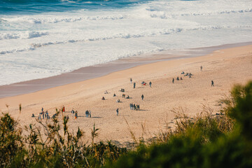 Tourists and locals enjoying a day at Nazaré beach