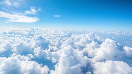 A breathtaking view of a beautiful blue sky with fluffy white clouds, as seen from an airplane window, capturing the serene and vast atmosphere above the earth. sky view from airpl
