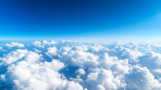 A breathtaking view of a beautiful blue sky with fluffy white clouds, as seen from an airplane window, capturing the serene and vast atmosphere above the earth. sky view from airpl