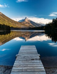 Fototapeta premium A glassy mountain lake perfectly reflecting the sky, with a small wooden dock extending into the serene waters, creating a tranquil and picturesque scene.