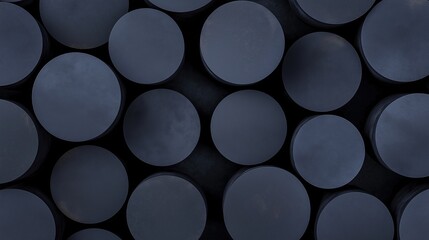 Close-up of a group of circular objects arranged in a grid-like pattern. the objects are all the same size and shape, and they are all dark blue in color.