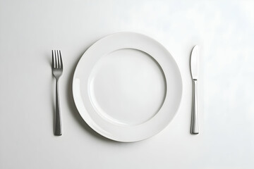 Elegant white plate setting with silverware for formal dining experiences