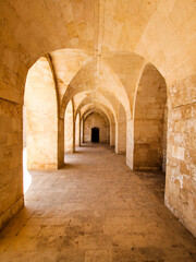 MARDIN Ancient stone arched walkway, sun-drenched interior passage. TURKIYE, TURKEY. Mardin old city.