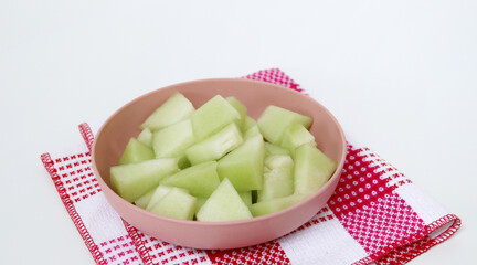Green melon fruit on wooden plate ready to eating