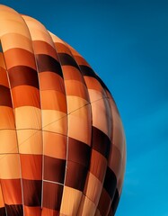 Macro hot air balloon fabric against blue sky: intricate weave, vibrant colors.  Unique texture detail for backgrounds and travel themes