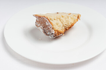 A single slice of sweet bread with raisins, isolated on a white plate.