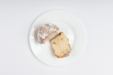 A top-down view of a sliced raisin cake with a golden crust and sugar dusting.