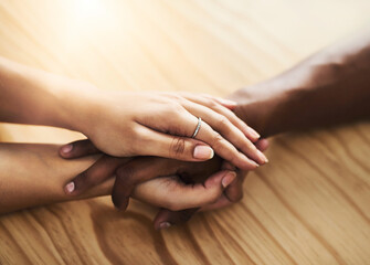 Interracial couple, hands and sympathy with support for relationship, commitment or trust at home....