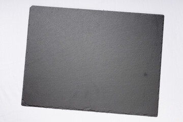 A dark grey slate board with a textured surface, isolated on a white background.