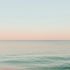 Calming evening sky reflected on tranquil ocean water with a soft gradient of pastel colors