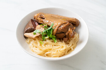 dried noodles with braised duck in white bowl