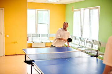 Two people playing table tennis. Man and woman compete in ping pong club