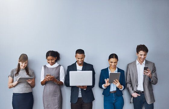 Technology, waiting or business people in queue for job interview, recruitment and hiring. Sign up, phone or candidates on laptop in studio for employment opportunity registration on gray background