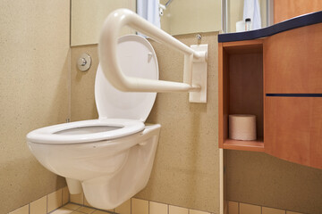 A public toilet for people with disabilities. Special plastic handrails in the bathroom. With space to copy. High quality photo