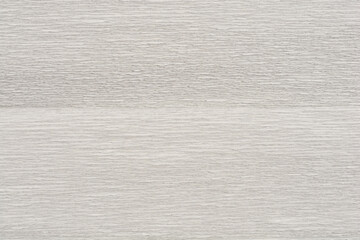 A close-up shot of textured white and gray crepe paper with a subtle, wavy pattern