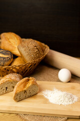 Sliced bread on the table, flour, egg. Homemade pastries. Freshly baked buns