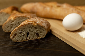 Slices of sliced bread on the table.Flour, egg, bread close-up.Homewort pastries