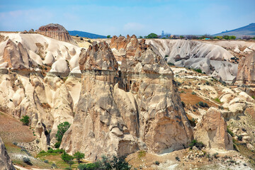 Unique rock formations rise majestically in the Cappadocia landscape under a clear blue sky