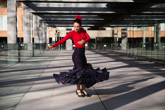 Flamenco dancer performing outdoors with skirt whirling - Powered by Adobe