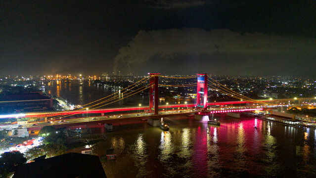 Aerial shot of Ampera Bridge at night, one of the landmarks of Palembang city, South Sumatra, Indonesia