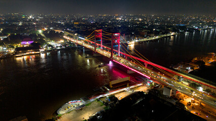 Aerial shot of Ampera Bridge at night, one of the landmarks of Palembang city, South Sumatra, Indonesia