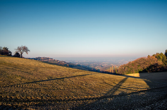 View of the medieval village of Montegridolfo, from the road from Belvedere Fogliense to Mondaino, before sunset.