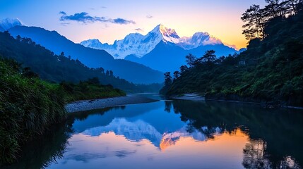 A peaceful river reflecting the jagged silhouette snow-capped peaks at sunrise