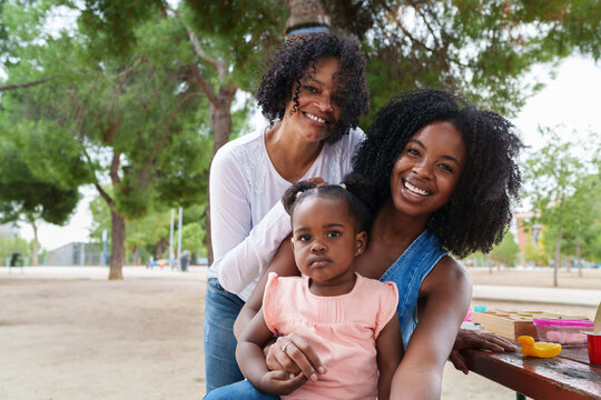Happy three generation family smiling together in park