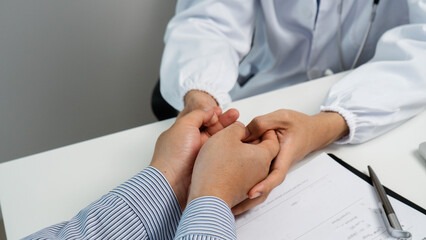 The hands of a doctor are comforting and encouraging a patient. Medical ethics and trust concept. Medical service, Healthcare