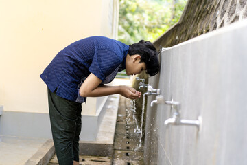 Muslim man taking ablution for prayer