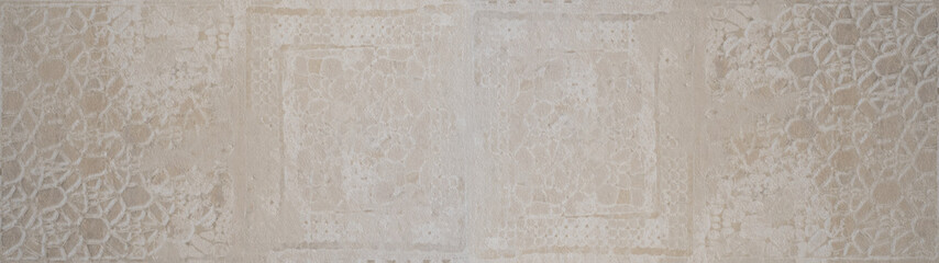 Old brown beige vintage worn shabby patchwork motif tiles tile stone concrete cement wall texture background banner long panorama.