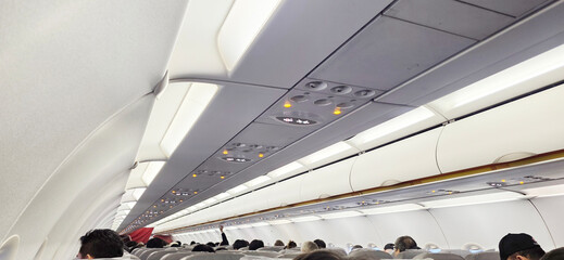 Interior of Airplane Cabin with Seated Passengers  