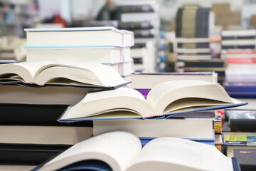 stack of books on the table. open book