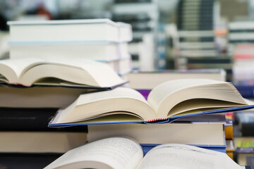 stack of books on the table. open book