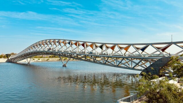 Experience the Atal Pedestrian Bridge at Sabarmati Riverfront, Ahmedabad, with this stunning landscape photo. Showcasing architectural brilliance against serene river views.
