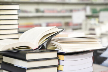 stack of books on the table. open book