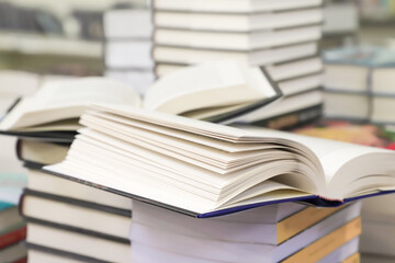 stack of books on the table. open book