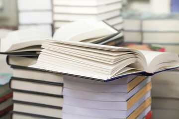 stack of books on the table. open book