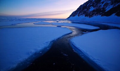 Antarctic twilight, ice floes, ocean channel, mountains