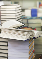 stack of books on the table. open book