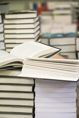 stack of books on the table. open book